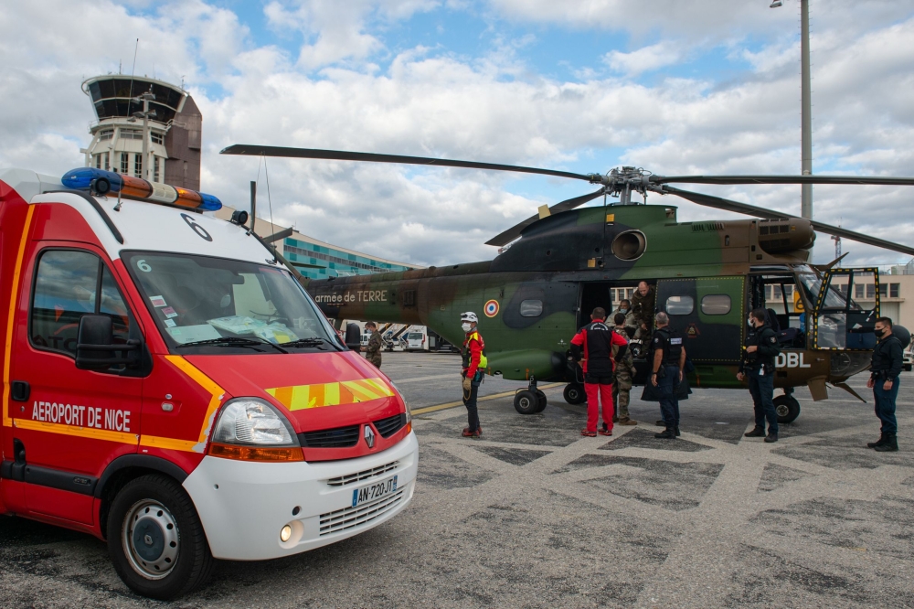 A handout photo made available on October 4, 2020 by the French Etat-Major des Armees shows people arriving at Nice airport after they were evacuated from areas hit by torrential rain and flash floods in the south of France. AFP PHOTO / ETAT-MAJOR DES ARM