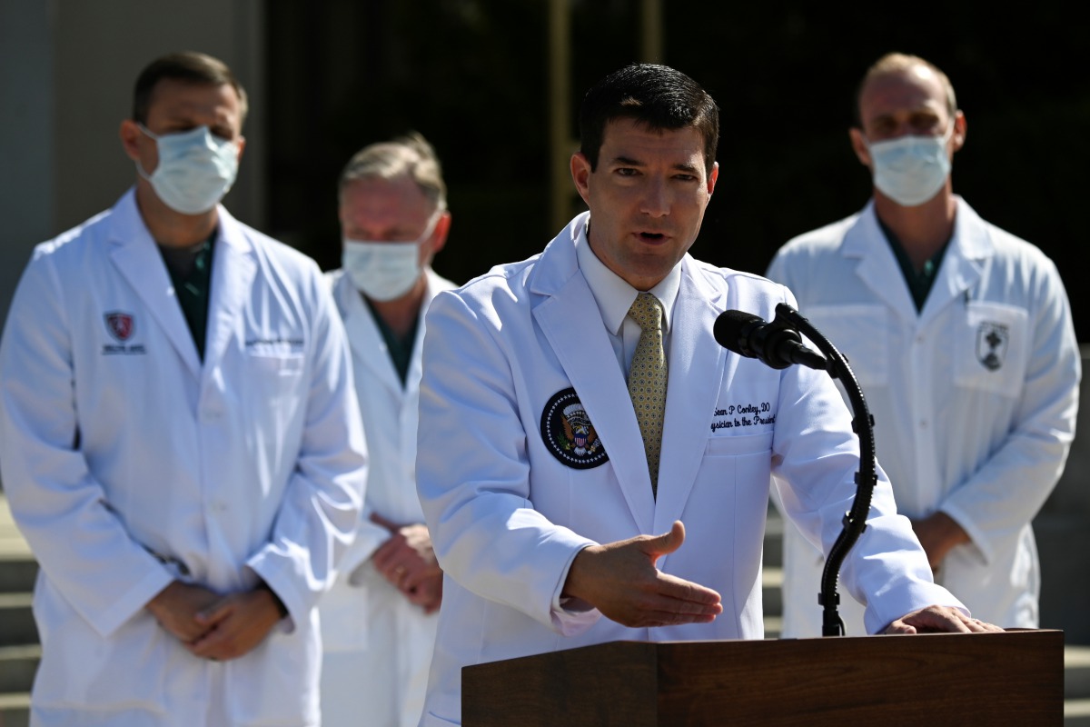U.S. Navy Commander Dr. Sean Conley, the White House physician, is flanked by other doctors as he speaks to the media about U.S. President Donald Trump's health after the president was hospitalized for the coronavirus disease (COVID-19) treatment, at Walt