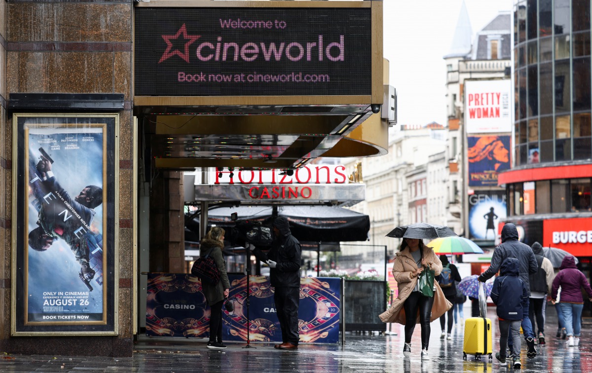 People walk past a Cineworld in Leicester's Square, amid the coronavirus disease (COVID-19) outbreak in London, Britain, October 4, 2020. REUTERS/Henry Nicholls
