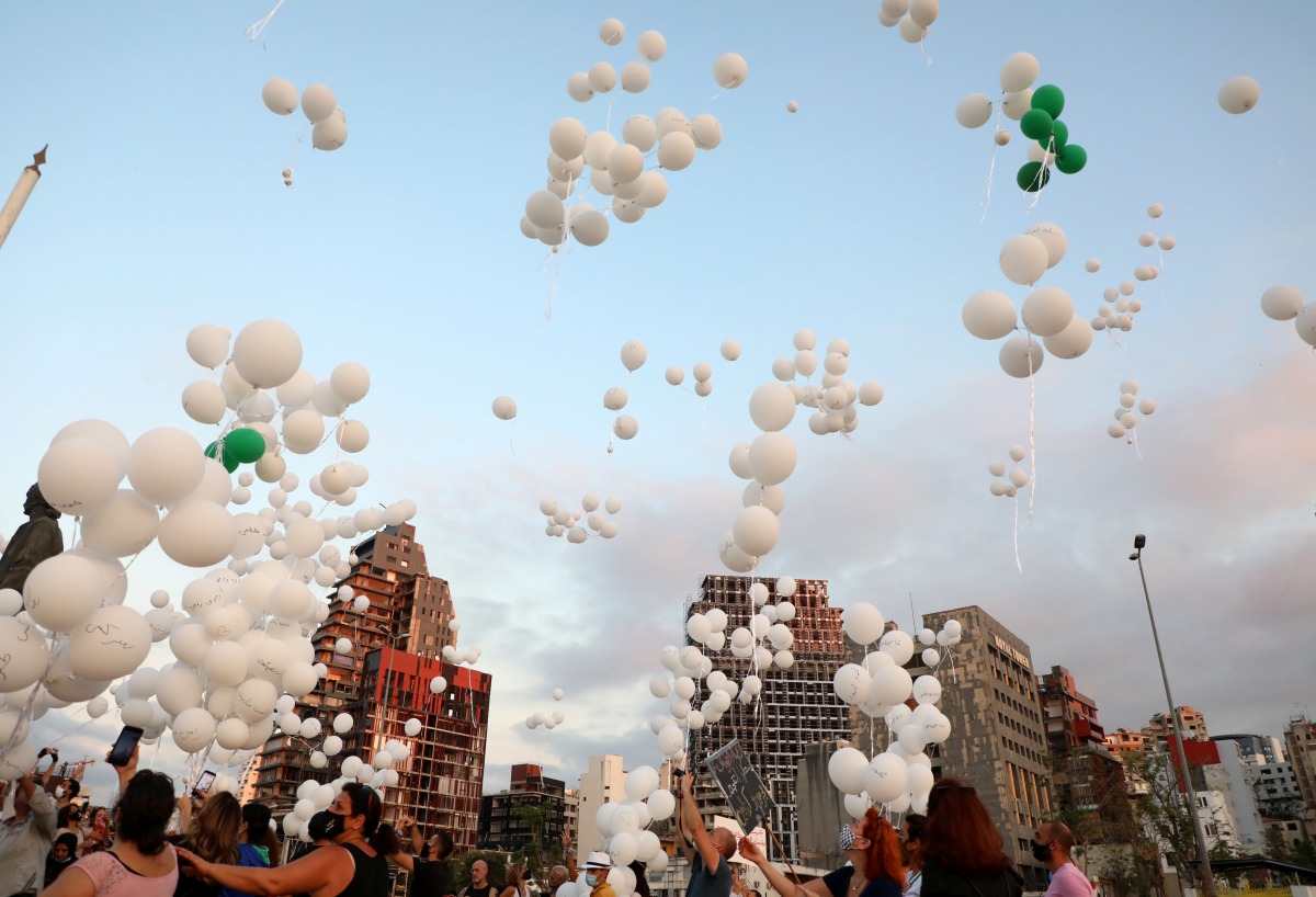 People release balloons during an event to commemorate the victims of the August 4 port explosion and to mark two months since the blast, near the port in Beirut, Lebanon October 4, 2020. REUTERS/Mohamed Azakir
