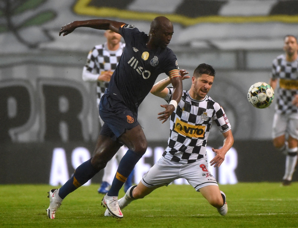 In this file photo taken on September 26, 2020 FC Porto's Portuguese midfielder Danilo Pereira (L) vies with Boavista's Brazilian forward Gustavo Sauer during the Portuguese league football match Boavista FC against FC Porto at the Estadio do Bessa Seculo