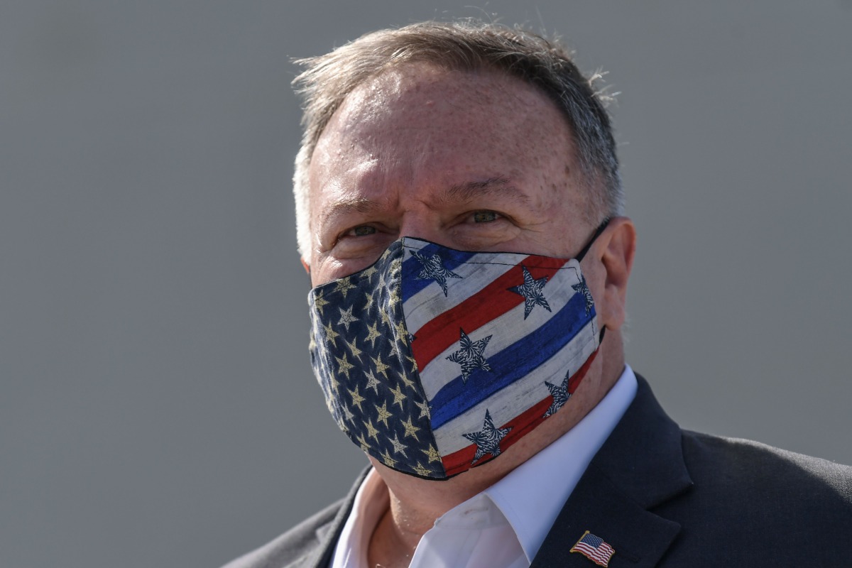 (FILES) In this file photo taken on September 29, 2020 US Secretary of State Mike Pompeo wears a protective face mask as he visits the Naval Support Activity base at Souda, the foremost US naval facility in the eastern Mediterranean on the Greek island of
