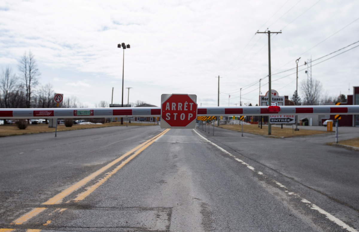 FILE PHOTO: An empty border crossing is seen leading into Rouses Point, NY at the U.S.-Canada border crossing in Lacolle, Quebec, Canada March 19, 2020. REUTERS/Christinne Muschi/File Photo
