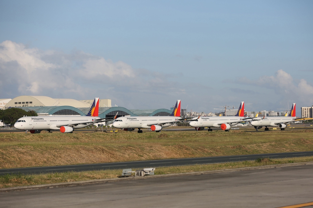 This file photo taken on April 19, 2020 shows passenger planes from carrier Philippine Airlines parked on the tarmac of Manila's international airport as air travel to and from the Philippines was suspended after the government implemented a lockdown in i
