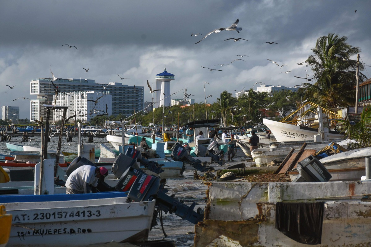 Fishermen from the coastal area of Cancun save their boats in preparation for the arrival of Hurrican Delta, in the state of Quintana Roo, Mexico on October 6, 2020. Hurricane Delta intensified into a Category 3 storm on Tuesday and is set to slam into Me