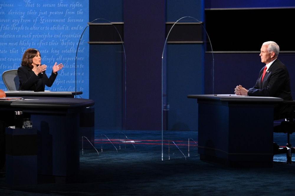 US Democratic vice presidential nominee and Senator from California, Kamala Harris (L) gestures toward US Vice President Mike Pence as she speaks during the vice presidential debate in Kingsbury Hall at the University of Utah on October 7, 2020, in Salt L