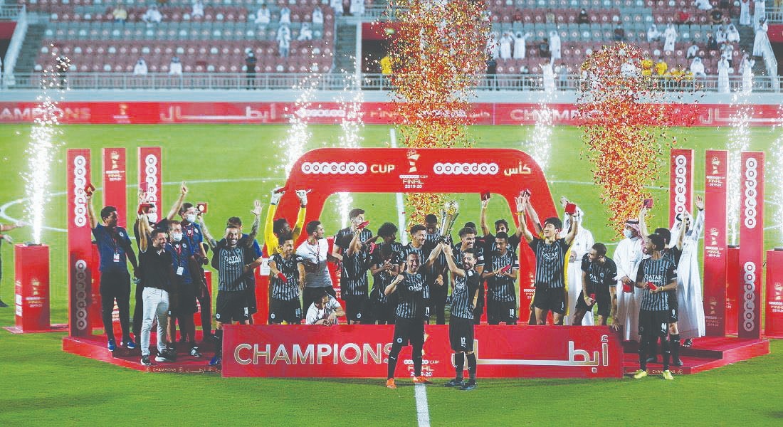 Al Sadd's players and officials celebrate withe the trophy after winning the Ooredoo Cup ?nal against Al Arabi at Al Duhail Stadium, yesterday.