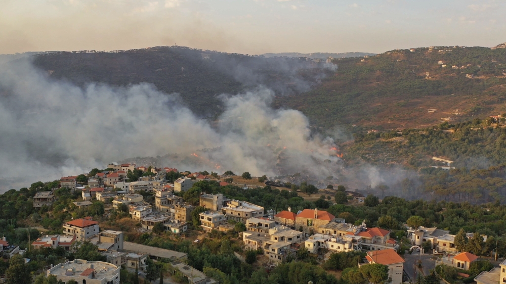 An aerial view shows smoke rising from a fire amid a heatwave in the Metn district of Mount Lebanon on October 9, 2020. / AFP 