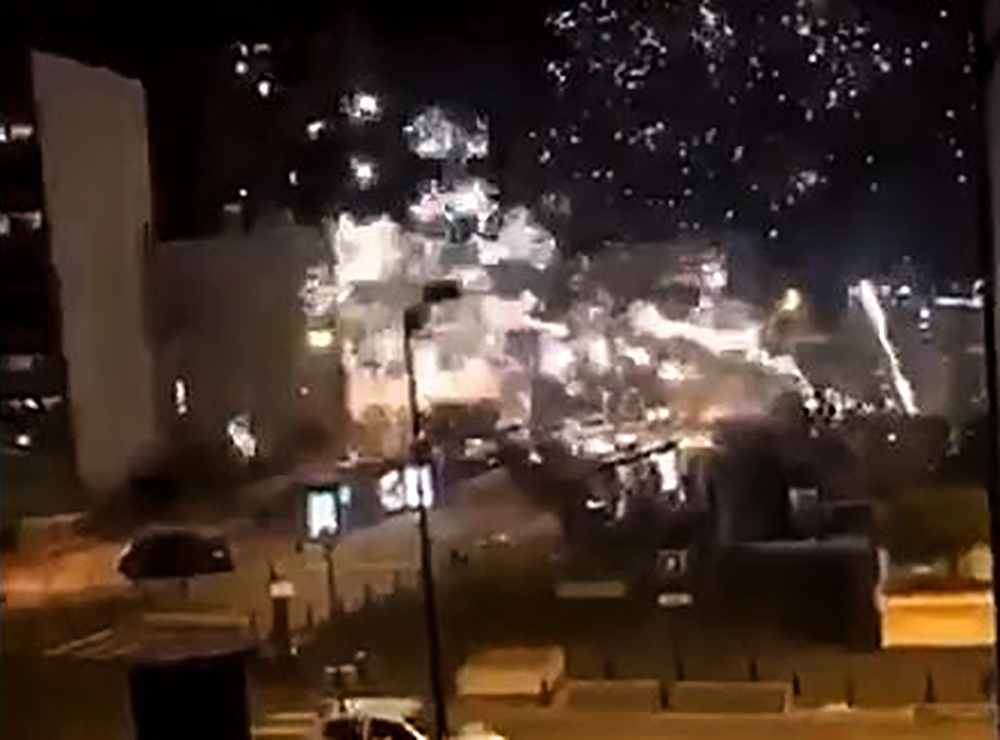 This handout image grab made from a video posted on the Twitter account of @LeCapricieux94 shows fireworks exploding outside the police station of Champigny-sur-Marne, outside Paris, in the night of October 10 to 11, 2020, as it is attacked by around 40 p