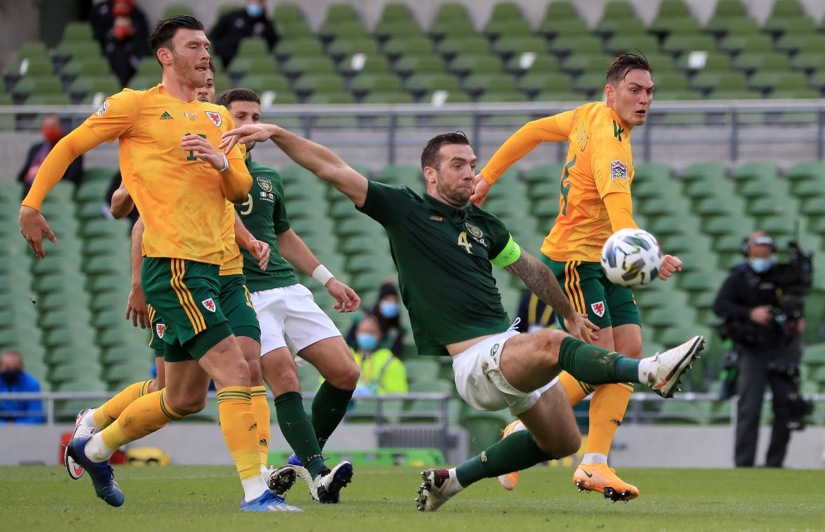 Wales' midfielder Kieffer Moore (L) and Wales' defender Connor Roberts (R) vie with Republic of Ireland's defender Shane Duffy during the UEFA Nations League Group B4 football match between the Republic of Ireland and Wales at the The Aviva Stadium in Dub