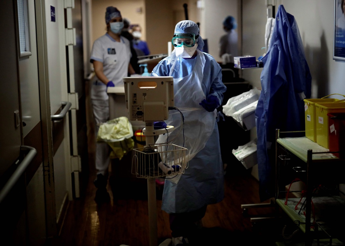 (FILES) In this file photo taken on April 07, 2020 Nurses use medical equipment as they tend to patients infected with COVID-19 at the intensive care unit of the Peupliers private hospital in Paris, on April 7, 2020, on the 22nd day of a strict lockdown i