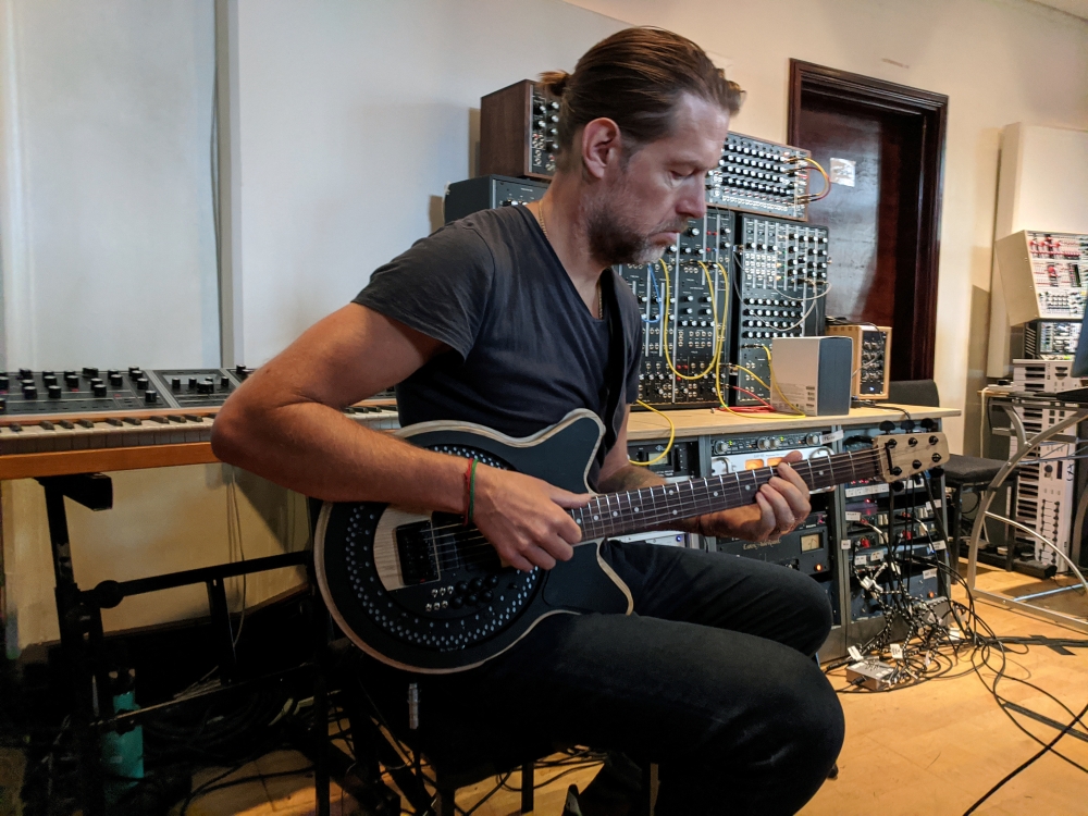Radiohead guitarist Ed O'Brien plays a Circle Guitar, a radical redesign of the instrument that strums itself, in a studio in London, Britain, October 1, 2020. Picture taken October 1, 2020. REUTERS/Stuart McDill