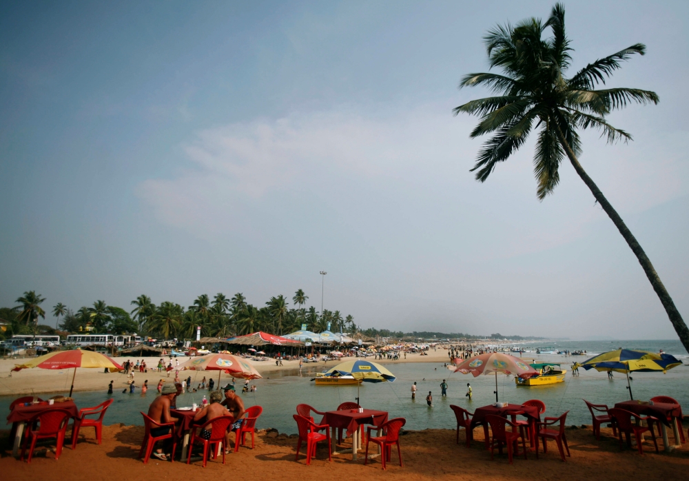 FILE PHOTO: Tourists relax at a cafe on Baga beach in the western Indian state of Goa March 16, 2008. REUTERS/Punit Paranjpe (INDIA)/File Photo