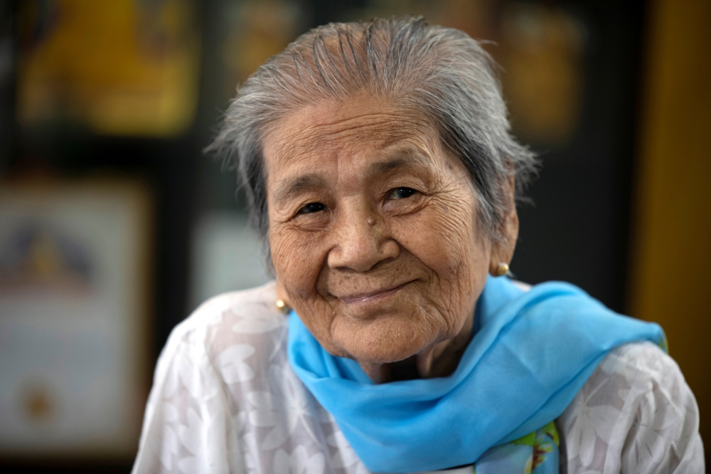 Daw Thein Khin, a 100-year-old woman survivor of the coronavirus disease (COVID-19) poses for a photo at her home, amid the outbreak of the disease, in Yangon, Myanmar, October 13, 2020. REUTERS/Shwe Paw Mya Tin
