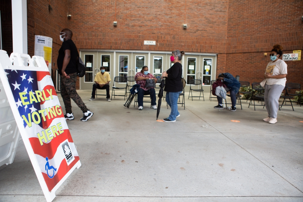 People stand in line on the first day of early voting for the general election at the C.T. Martin Natatorium and Recreation Center on October 12, 2020 in Atlanta, Georgia. 