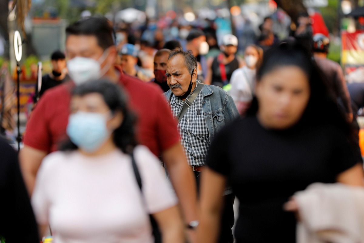 FILE PHOTO: People walk on the street, as the coronavirus disease (COVID-19) outbreak continues, in MEXICO City, MEXICO October 8, 2020. REUTERS/Carlos Jasso/File Photo
