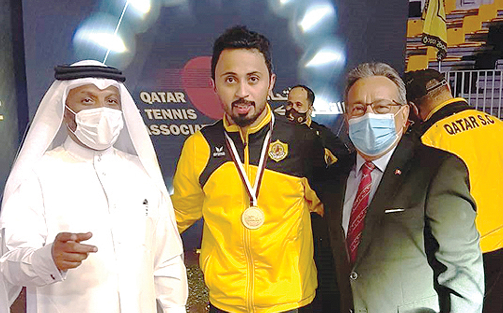 Qatar SC's Ahmed Khalil Al Mohannadi posing for a photograph with the Ambassador of Peru to Qatar, H E Jose Benzaquen, and the President of the Qatar Table Tennis Association, Khalil Al Mohannadi (left) after winning the Amir Cup on Monday.