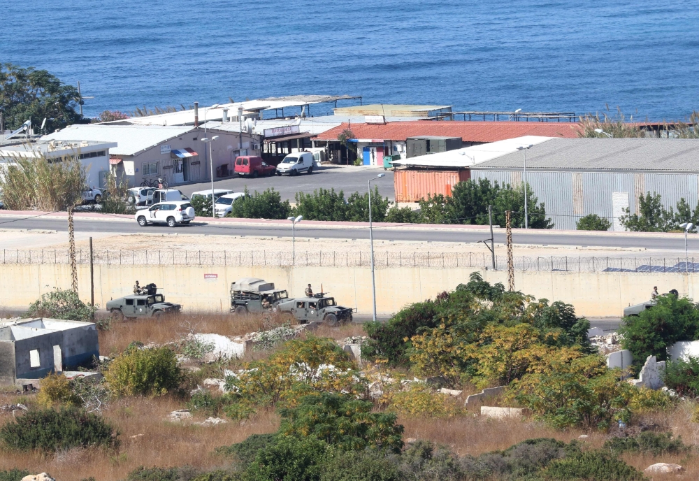 A general view shows UNIFIL and Lebanese military vehicles guarding the area around the UNIFIL base (not seen in picture) where Israeli and Lebanese delegtaions were having their first round of talks in the southern Lebanese border town of Naqura on Octob
