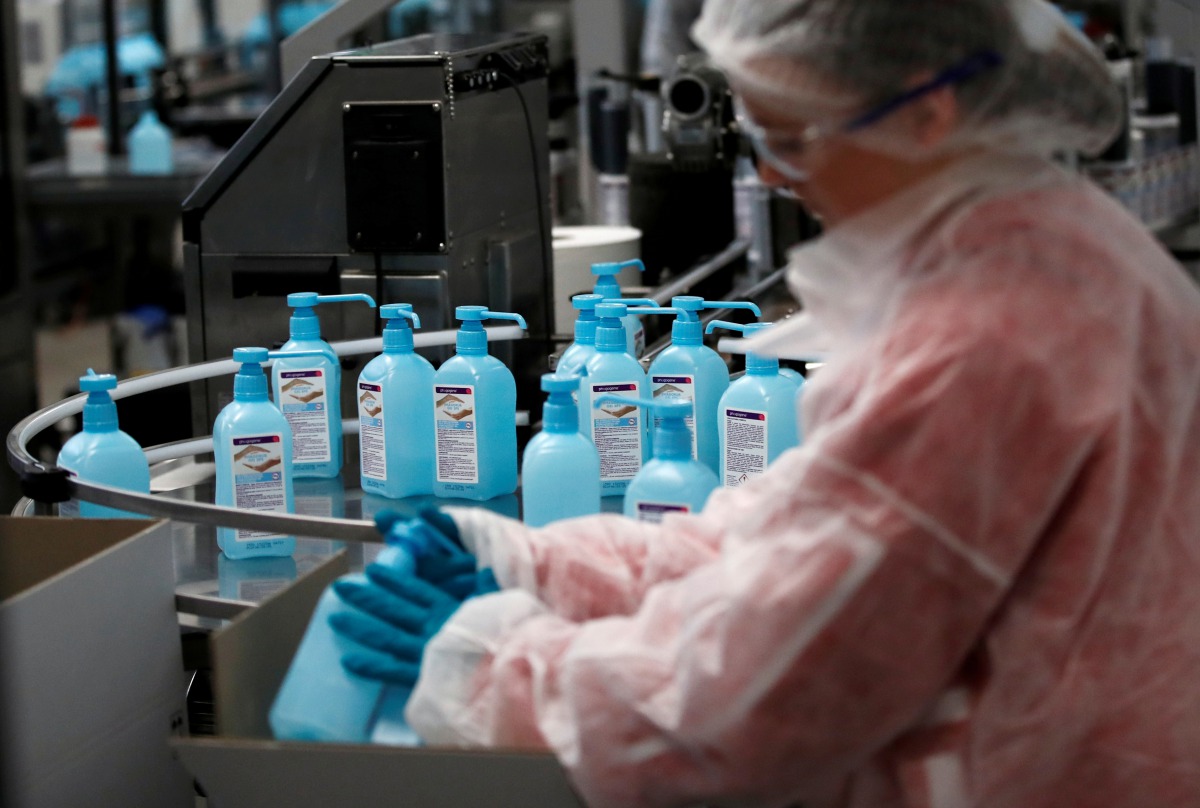 FILE PHOTO: An employee works on the production of hydroalcoholic gel at the Christeyns company's factory in Vertou near Nantes, France, March 6, 2020. REUTERS/Stephane Mahe/File Photo
