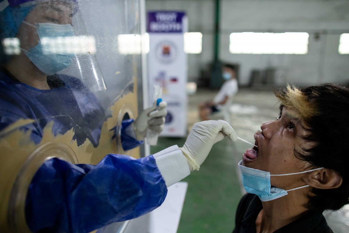 A vendor at Pritil Public Market gets a free swab test amid the coronavirus disease (COVID-19) outbreak, in Tondo, Manila, Philippines, October 8, 2020. REUTERS/Eloisa Lopez
