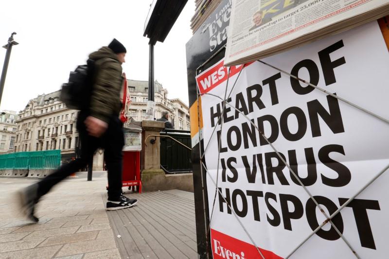 FILE PHOTO/Newspaper headline on display at Oxford Circus in London as the spread of the coronavirus disease (COVID-19) continues, in London, Britain, March 18, 2020. REUTERS/John Sibley
