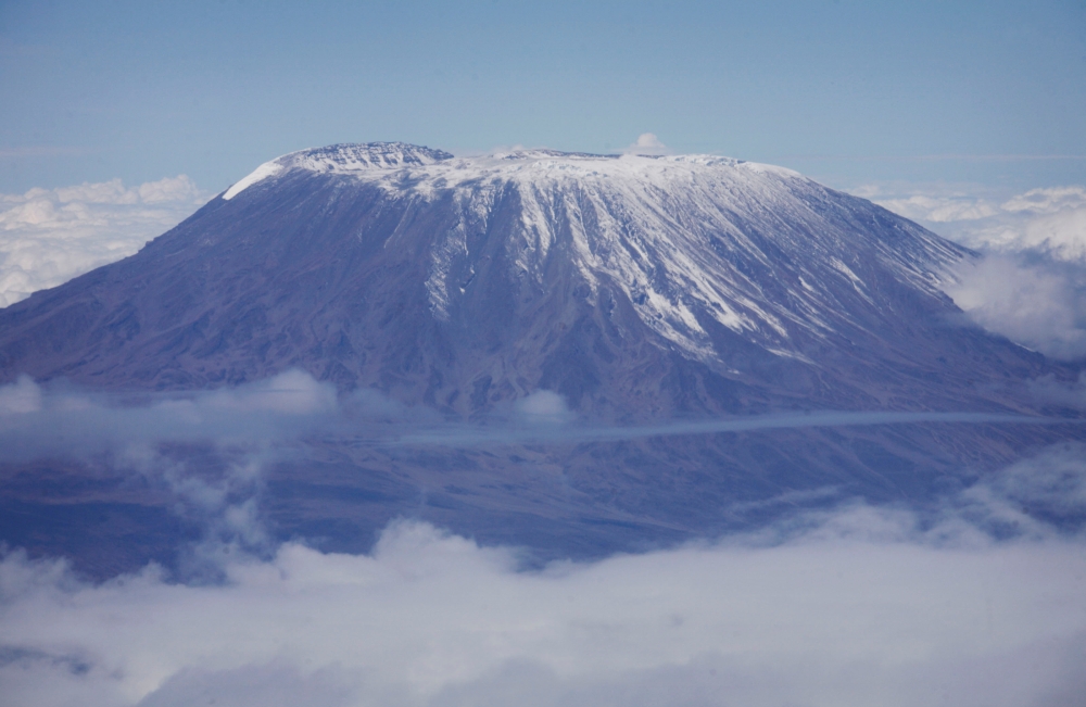 A fresh dusting of snow sits atop the dormant volcano of Mount Kilimanjaro, Africa's highest peak, in northern Tanzania, November 22, 2007. REUTERS/Finbarr O'Reilly/File Photo/File Photo