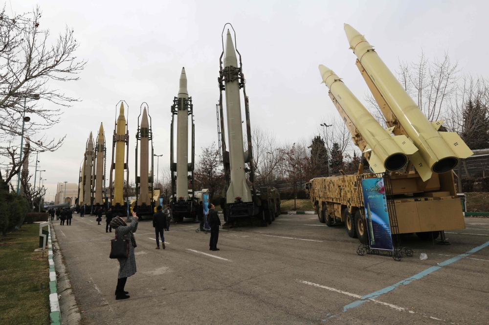 (FILES) A file photo taken on February 2, 2019, shows Iranians visiting a weaponry and military equipment exhibition in the capital Tehran, organised on the occasion of the 40th anniversary of the Iranian revolution. AFP / Atta Kenare 