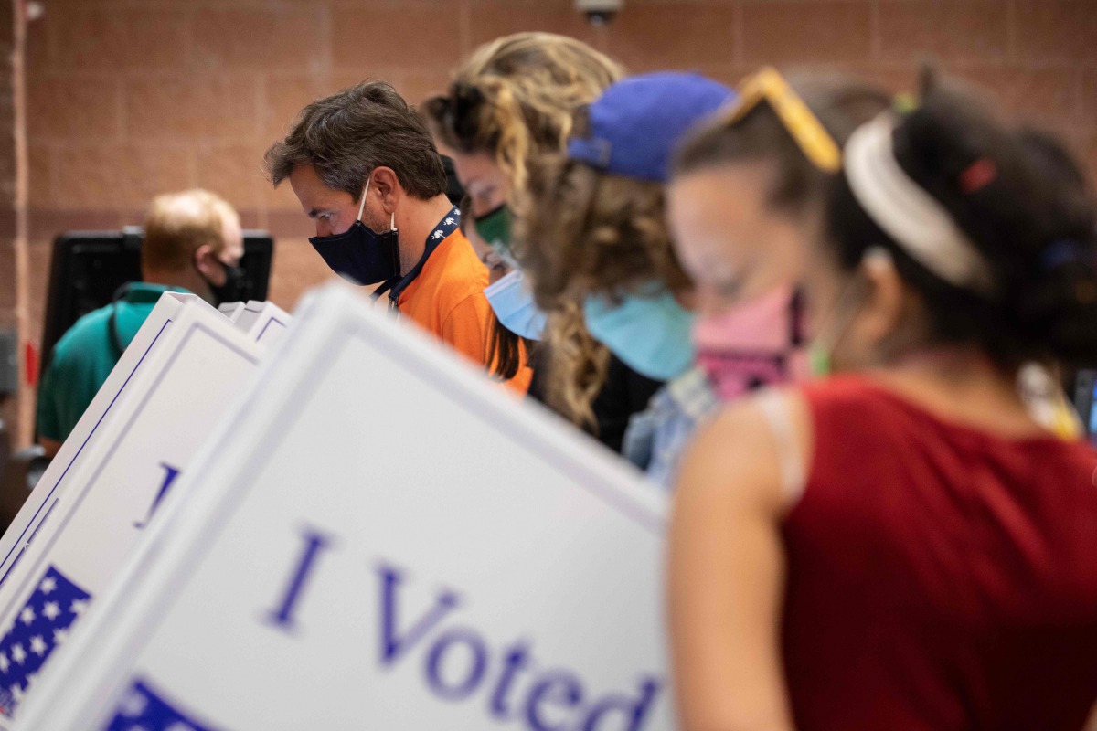 Voters cast their ballots in the voting booths at the early vote location at the Charleston Coliseum and Convention Center in North Charleston, South Carolina on October 16, 2020. Many states across the country have seen record turnout for early voting fo