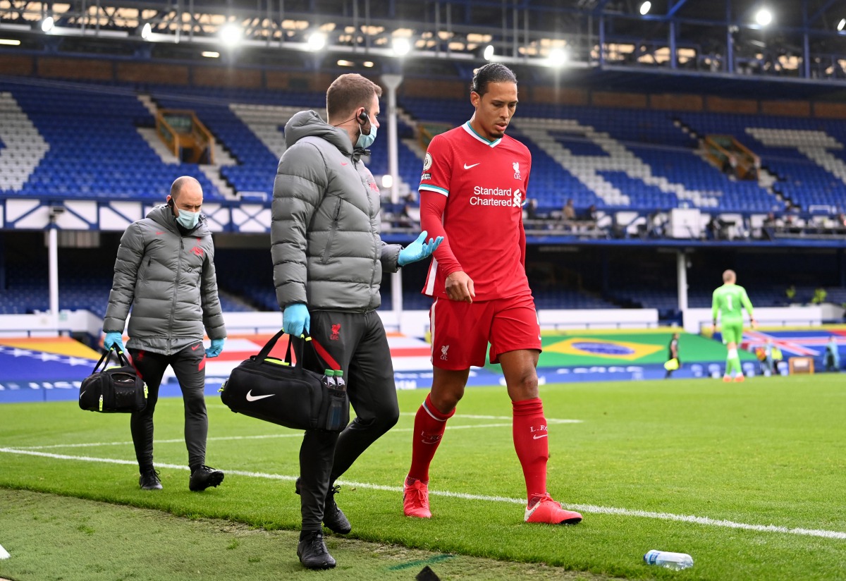 Soccer Football - Premier League - Everton v Liverpool - Goodison Park, Liverpool, Britain - October 17, 2020 Liverpool's Virgil Van Dijk receives medical attention after sustaining an injury Pool via REUTERS/Laurence Griffiths