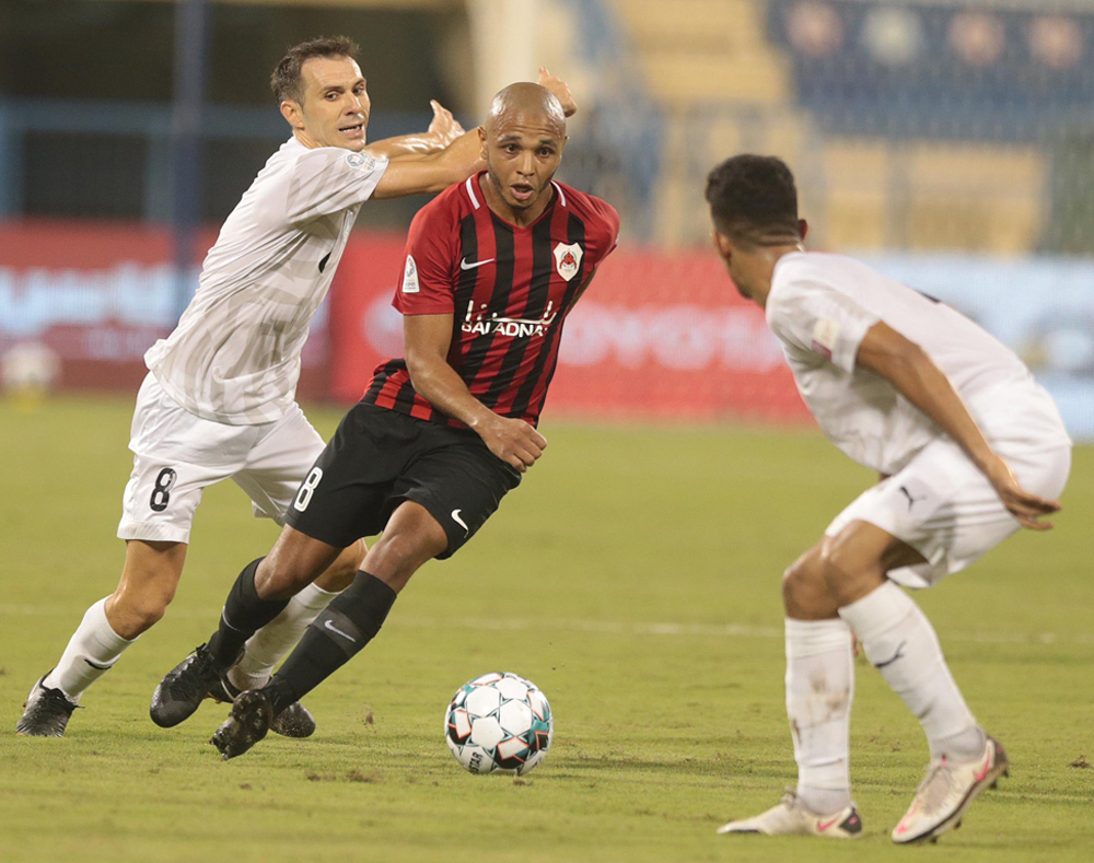 Al Rayyan's Yacine Brahimi (centre) vies for the ball with Al Wakrah players during yesterday's match.