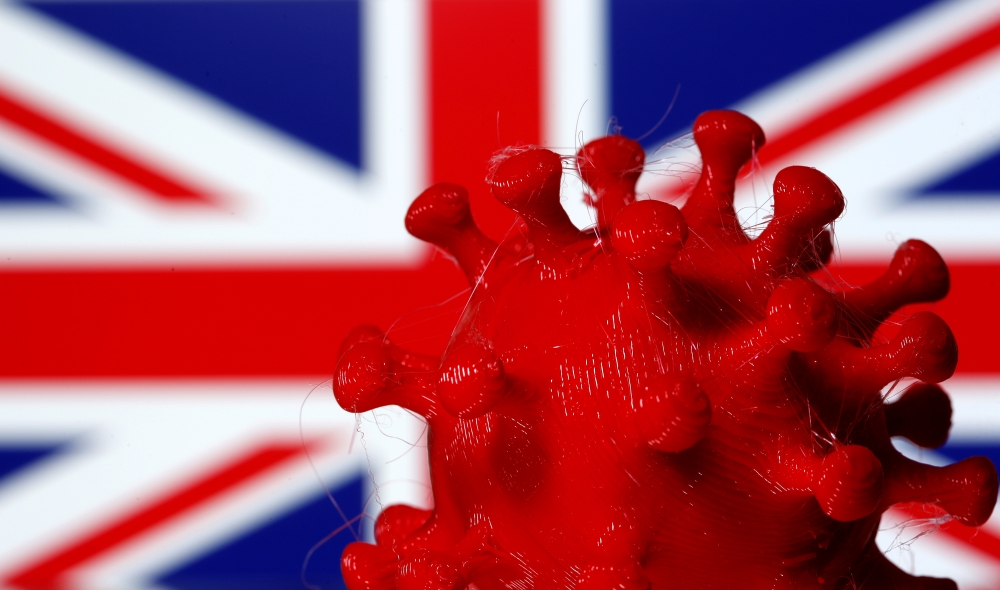 A 3D-printed coronavirus model is seen in front of a British flag on display in this illustration taken March 25, 2020. REUTERS/Dado Ruvic/Illustration/File Photo