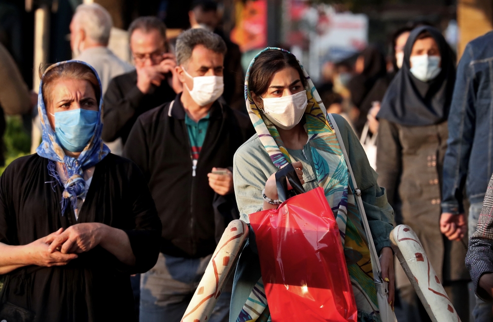 Iranians wear face masks as a Covid-19 coronavirus pandemic precaution, in Iran's capital Tehran on October 19, 2020. Iran today announced 337 deaths from the novel coronavirus, a record high for a single day in the Middle East country hardest hit by the 