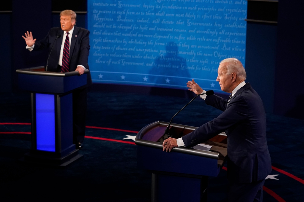 (FILES) In this file photo taken on September 29, 2020 US President Donald Trump and former Vice President and Democratic presidential nominee Joe Biden speak during the first presidential debate at the Health Education Campus of Case Western Reserve Univ