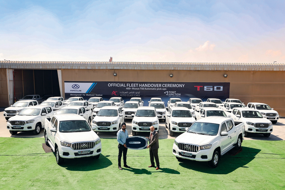 Harvinder Sahni (left), Head of Operations, Point Junction Company formally receiving the delivery of vehicles from Hisham Al Sahn, General Manager of Auto Class Cars. 