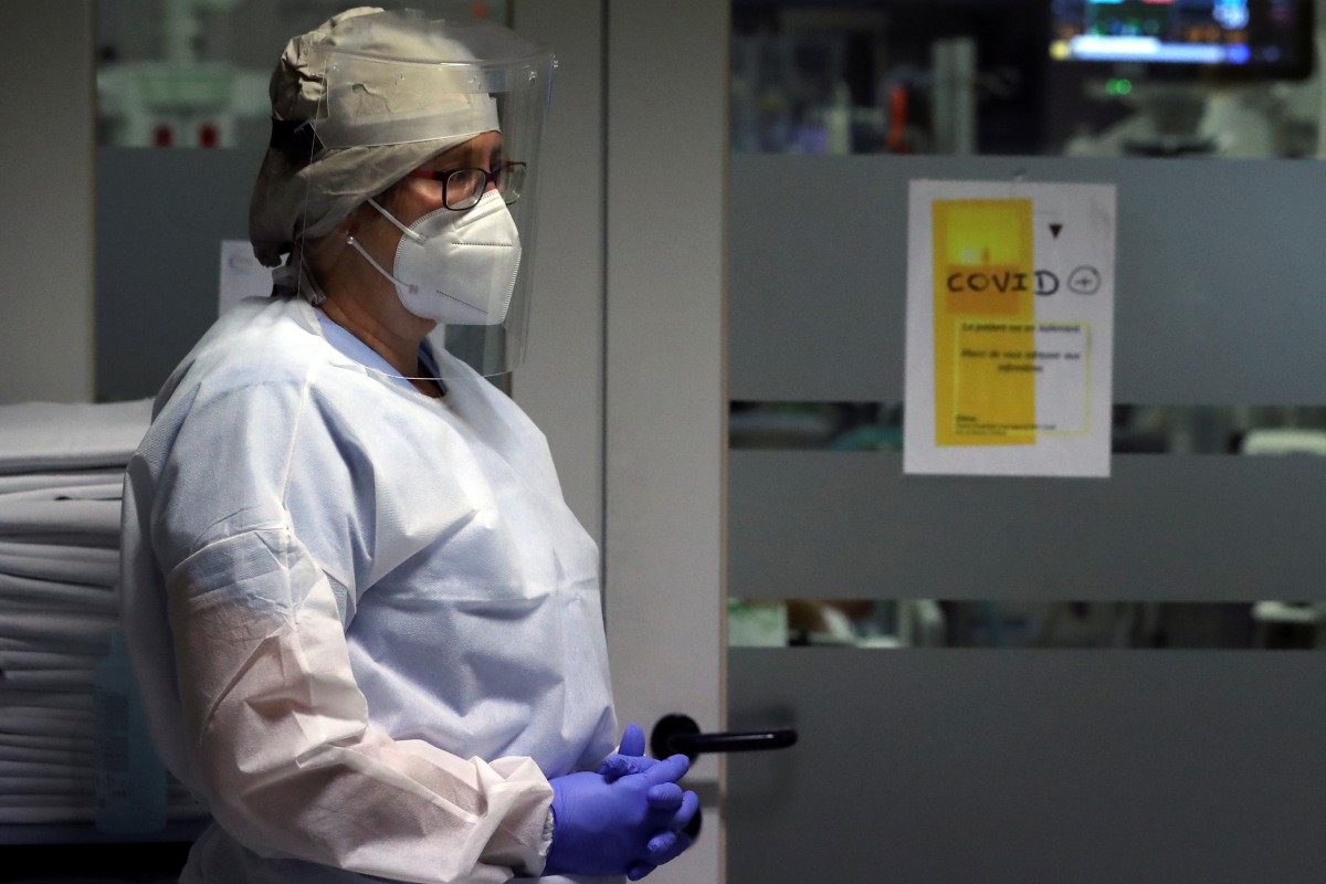 A member of the medical personnel wearing a protective suit, protective mask and face shield is seen in the intensive care unit at the CHIREC Braine l?Alleud-Waterloo hospital, in Braine l'Alleud, Belgium, October 23, 2020