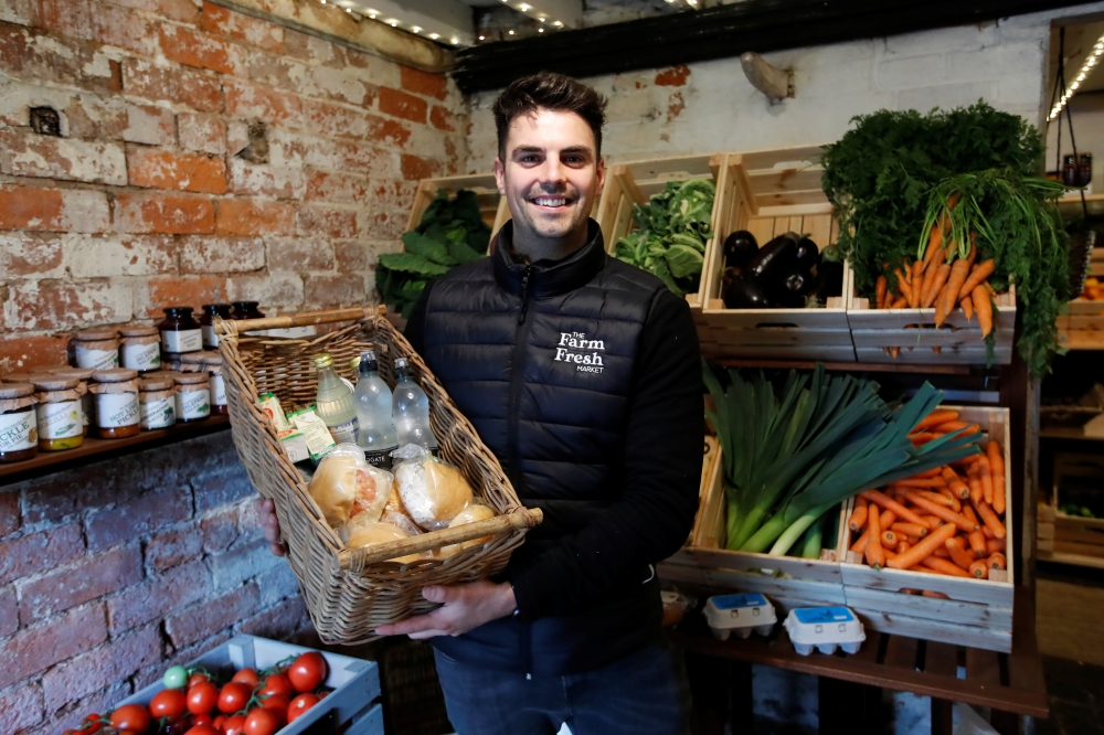 Alex Stephens, the owner The Farm Fresh Market, poses for a picture at his farm shop that has offered free lunches to children who need it over half term, after reacting to footballer Marcus Rashford's online post, as the spread of coronavirus diseases (C