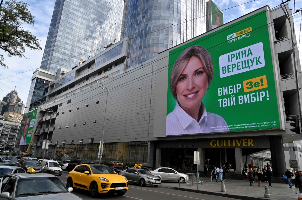 A huge screen displays an election campaign ad of mayoral candidate from president Volodymyr Zelensky's ruling Servant of the People party Iryna Vereshchuk in the center of the Ukrainian capital of Kiev on October 23, 2020, ahead of October 25 local elect
