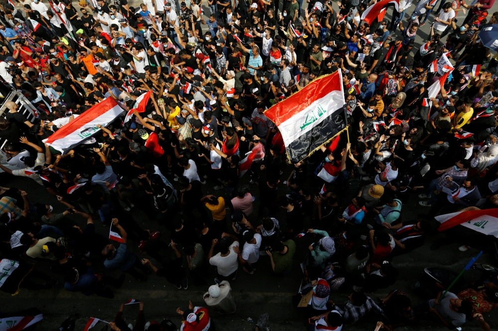 Iraqi demonstrators gather to mark the first anniversary of the anti-government protests in Baghdad, Iraq October 25, 2020. REUTERS/Thaier Al-Sudani