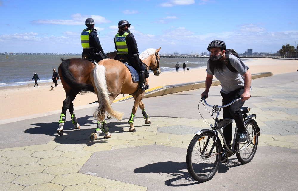 Police patrol on horseback along the St Kilda Esplanade in Melbourne on October 26, 2020 as Australian health officials reported no new coronavirus cases or deaths in Victoria state, which has spent months under onerous restrictions after becoming the epi