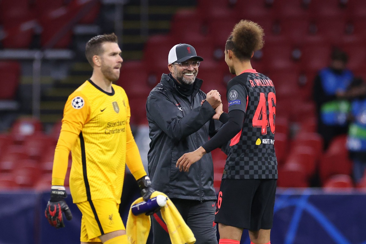 Liverpool's German coach Jurgen Klopp (C) celebrates with Liverpool's English defender Rhys Williams after winning the UEFA Champions League Group D first-leg football match between Ajax Amsterdam and Liverpool FC at the Johan Cruijff Arena in Amsterdam o