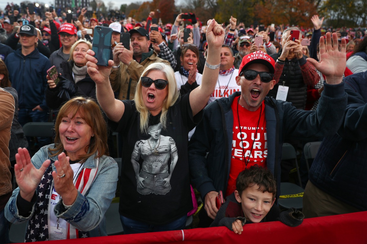 Supporters cheer as U.S. President Donald Trump delivers remarks during a campaign event at the Pickaway Agriculture and Event Center in Circleville, Ohio, U.S., October 24, 2020. REUTERS/Tom Brenner
