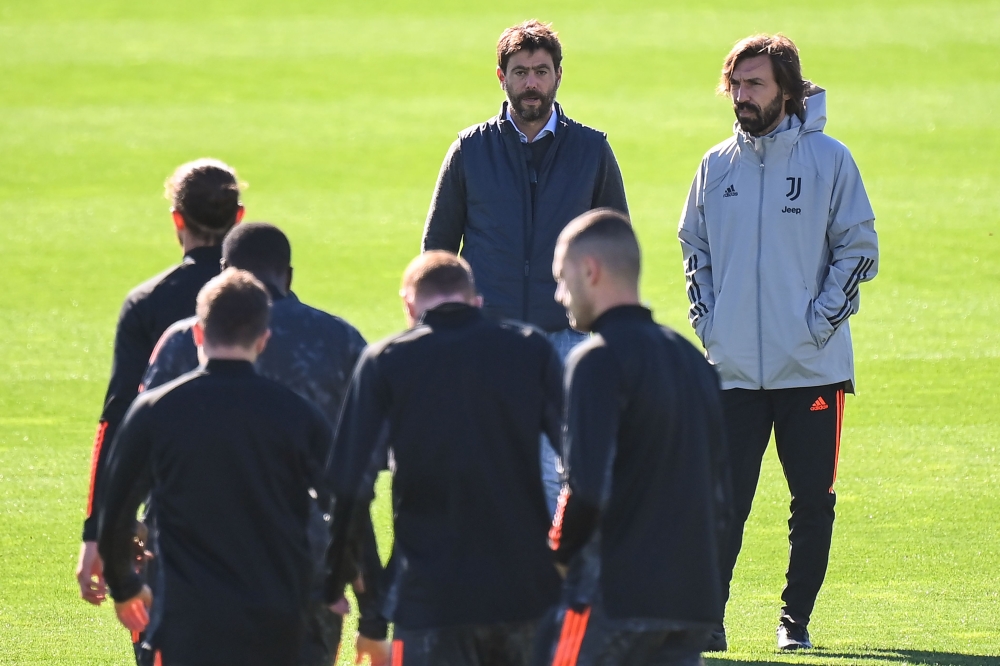 Juventus president Andrea Agnelli (C) and Juventus coach Andrea Pirlo (R) attend a training session on the eve of the UEFA Champions League football group G match Juventus vs F.C. Barcelona on October 27, 2020 at the Juventus Training Center in Turin. / A
