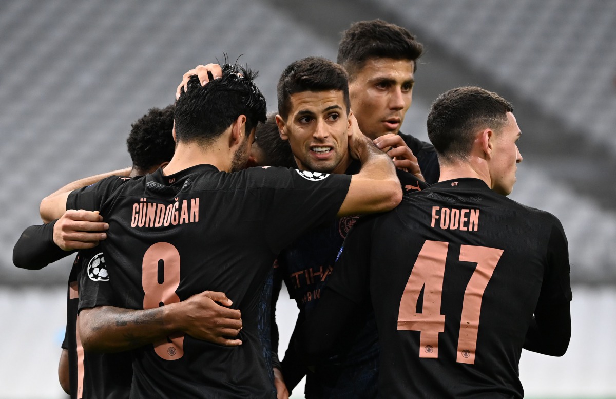 Manchester City's German midfielder Ilkay Gundogan celebrates with team mates after scoring a goal during the UEFA Champions League Group C football match between Olympique de Marseille and Manchester City on October 27, 2020 at the Velodrome Stadium in M
