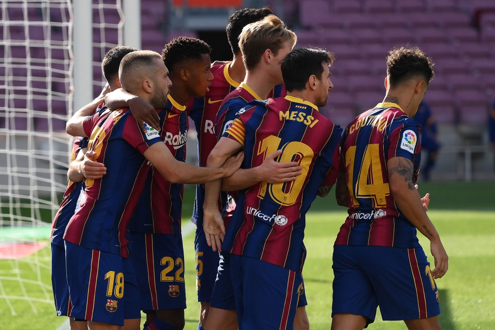 Barcelona's Spanish midfielder Ansu Fati (3rdL) celebrates with teammates after scoring a goal during the Spanish League football match between Barcelona and Real Madrid at the Camp Nou stadium in Barcelona on October 24, 2020. / AFP / LLUIS GENE
