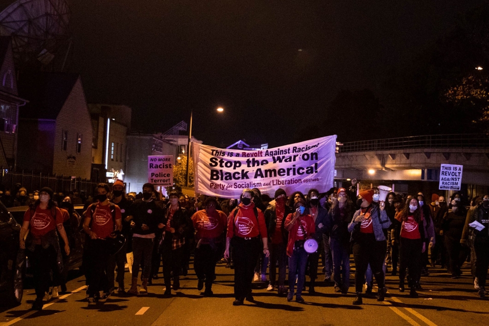 Protesters march through West Philadelphia on October 27, 2020, during a demonstration against the fatal shooting of 27-year-old Walter Wallace, a Black man, by police. AFP / GABRIELLA AUDI