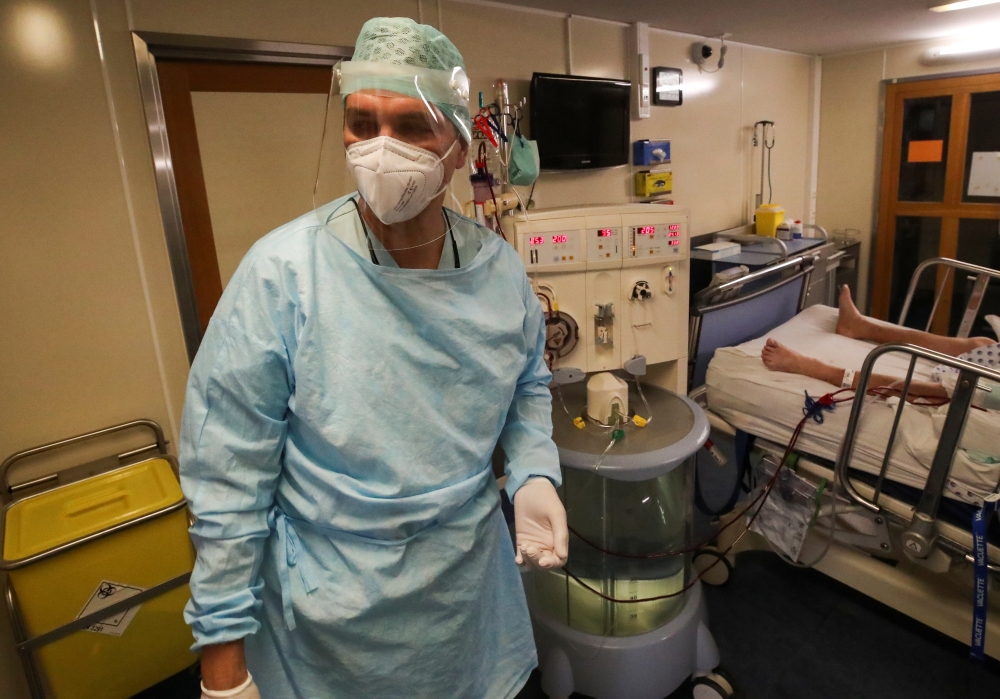 A member of the medical personnel at the CHU de Liege hospital looks on as they treat patients suffering from the coronavirus disease (COVID-19), in Liege, Belgium October 27, 2020. REUTERS/Yves Herman