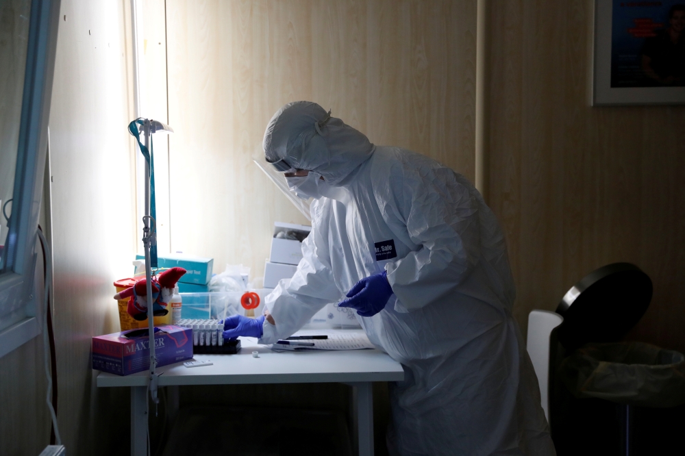 A healthcare worker works at a COVID-19 testing site as the spread of the coronavirus disease (COVID-19) continues in Budapest, Hungary, October 27, 2020. REUTERS/Bernadett Szabo/File Photo