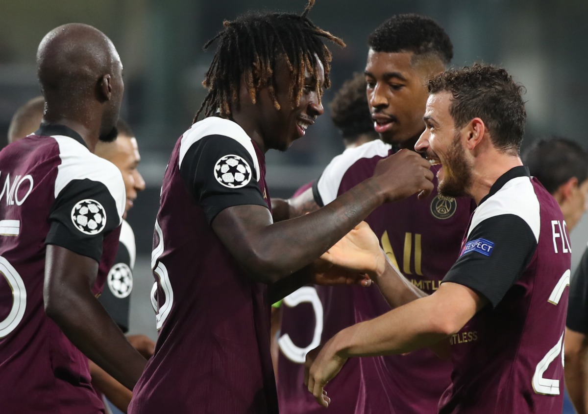 Paris Saint-Germain's Italian forward Moise Kean (L) celebrates with Paris Saint-Germain's Italian midfielder Alessandro Florenzi after scoring his team's first goal during the UEFA Champions League Group H football match between Istanbul Basaksehir FK an