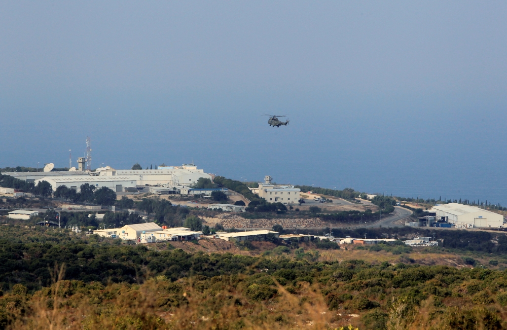 An aircraft flies over a base for U.N. peacekeepers of the United Nations Interim Force in Lebanon (UNIFIL) in Naqoura, near the Lebanese-Israeli border, southern Lebanon October 29, 2020. REUTERS/Aziz Taher