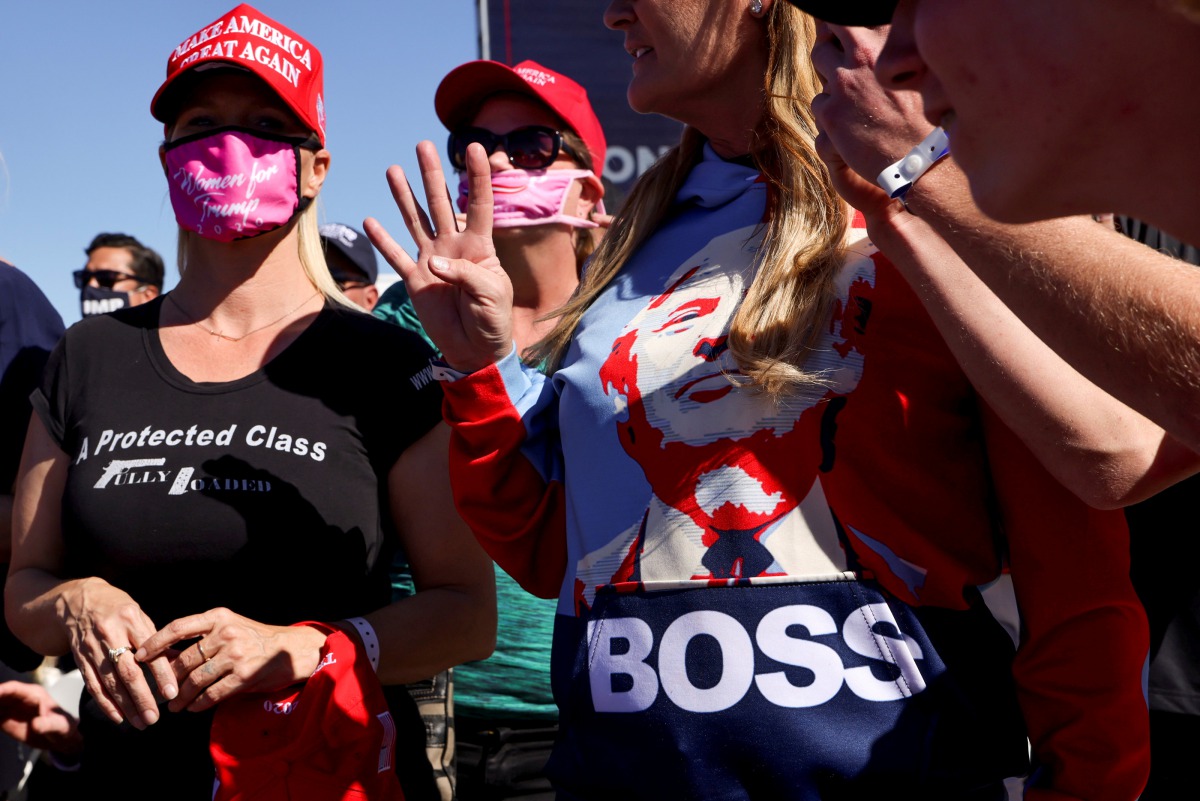 FILE PHOTO: A supporter holds up four fingers during U.S. President Donald Trump's campaign rally at Laughlin/Bullhead International Airport in Bullhead City, Arizona, U.S., October 28, 2020. REUTERS/Jonathan Ernst/File Photo
